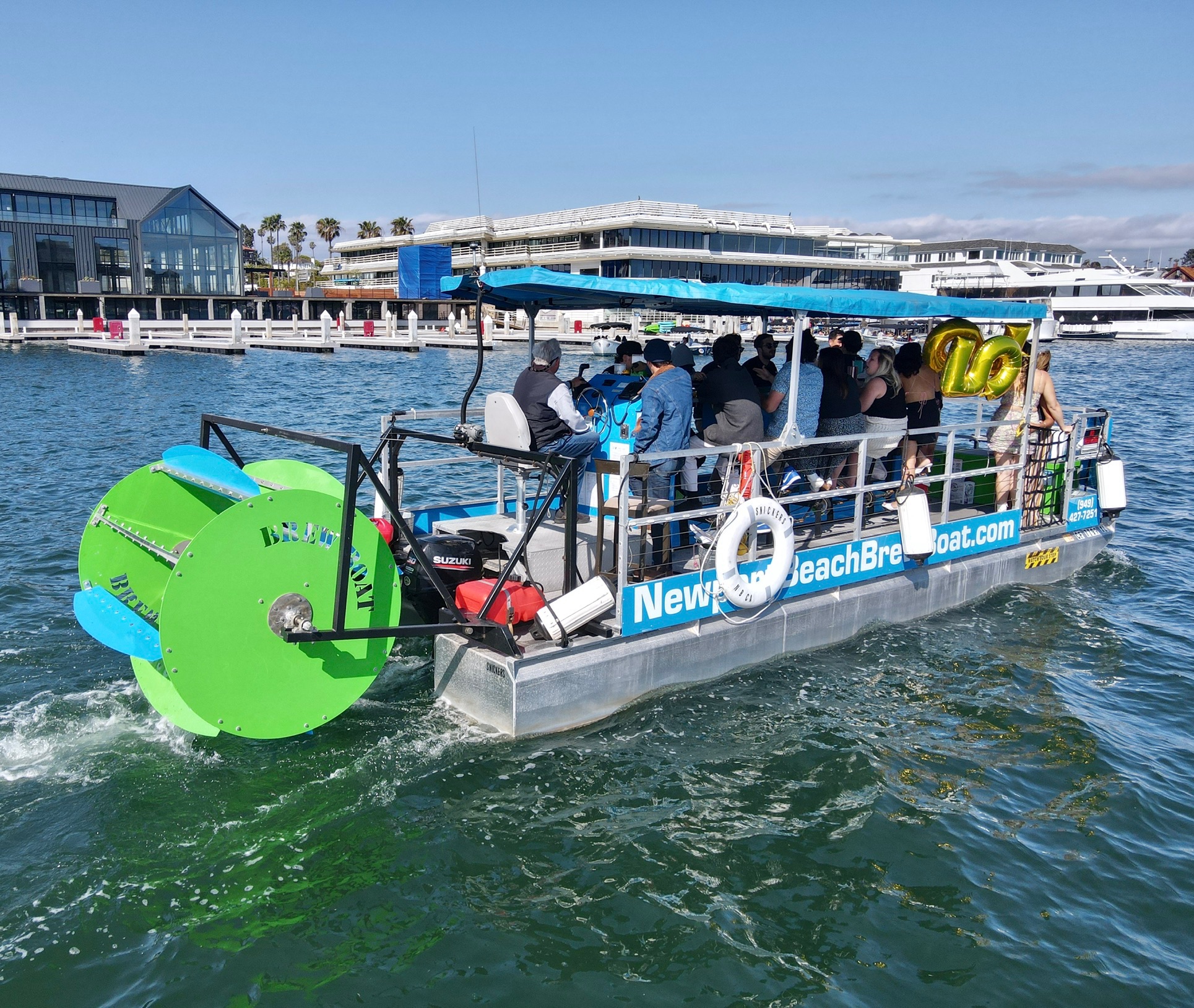 Paddle Pub cycle boat cruising in Newport Beach harbor with passengers